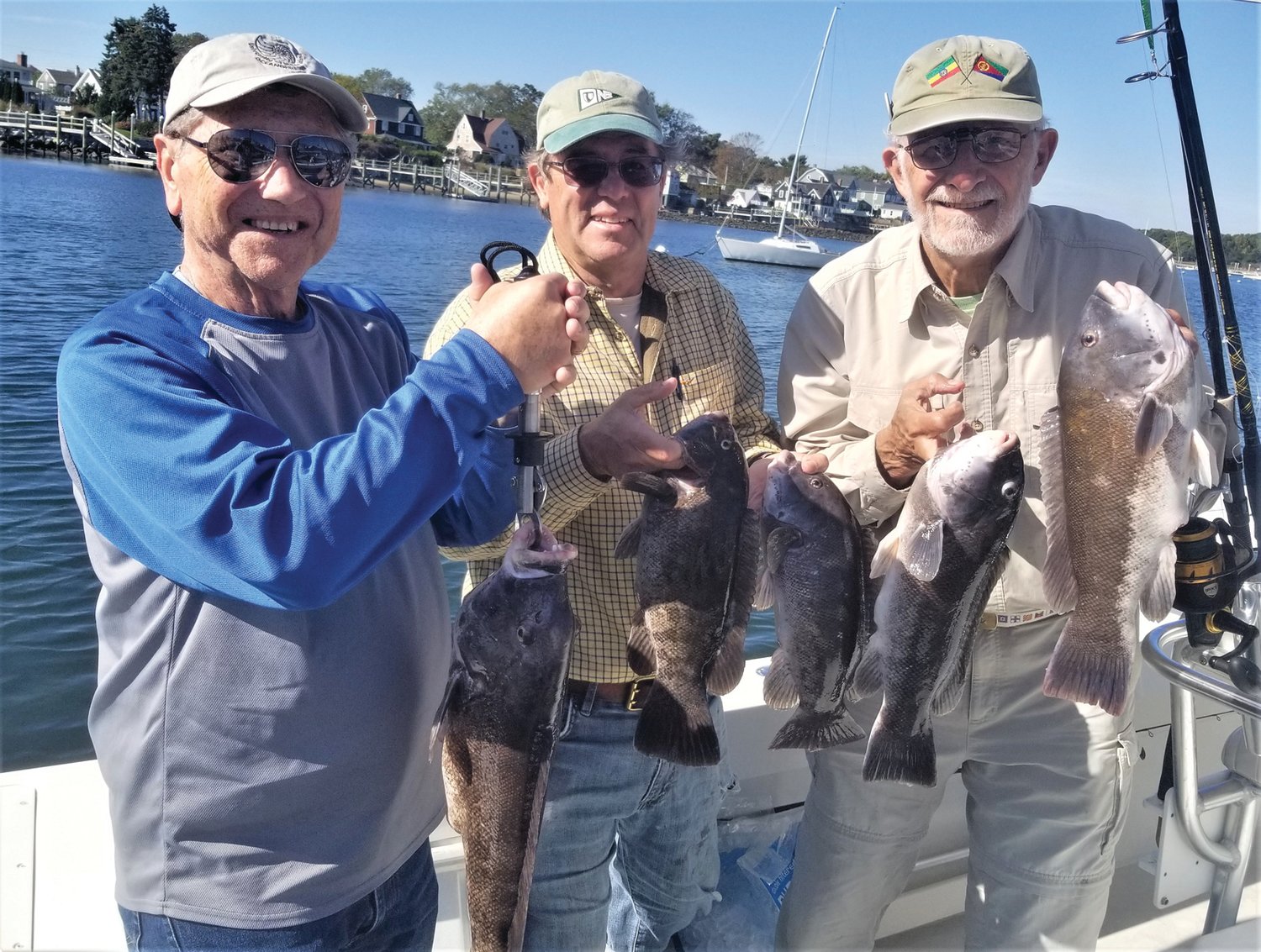 TAUTOG JUNKIES: Chris Deacutis with the 23-inch tautog he caught fishing with Hal Walker and Walt Galloway off Newport this October. The trio caught their ten fish boat limit. 